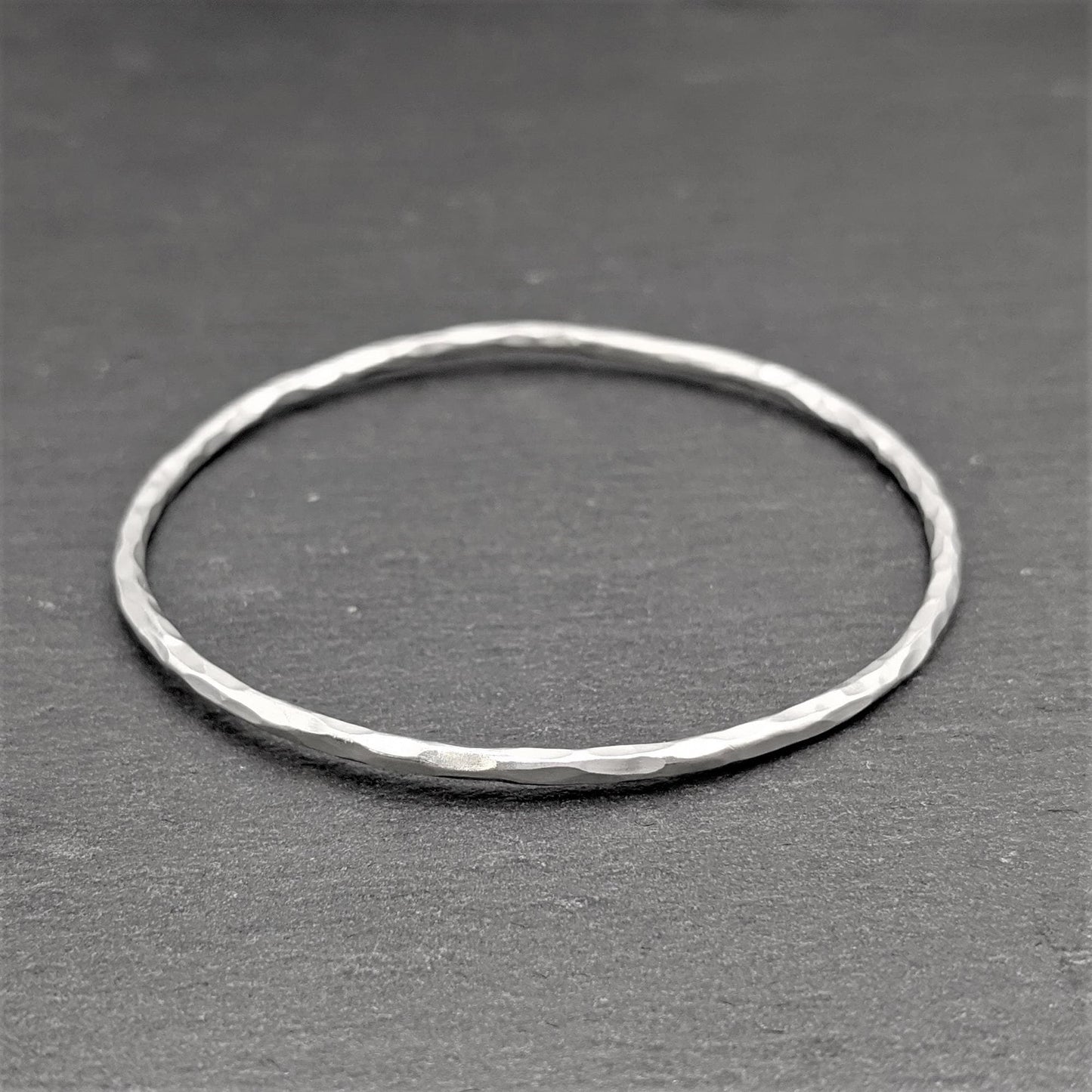
                  
                    Pure Silver Karen Hill Tribe Minimalist Hammered Tube Stackable Bangle
                  
                