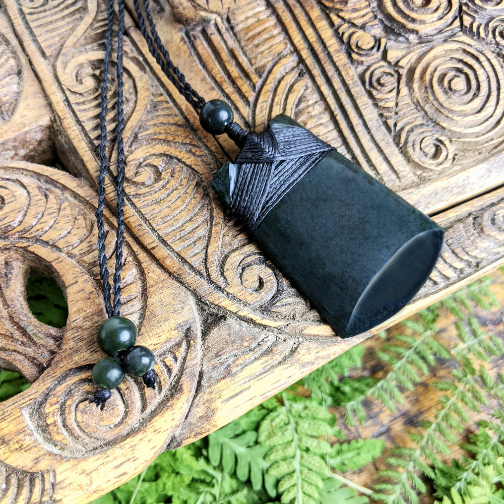 
                  
                    Dark Nephrite Jade Maori Style Toki Blade Pendant Cord Necklace
                  
                